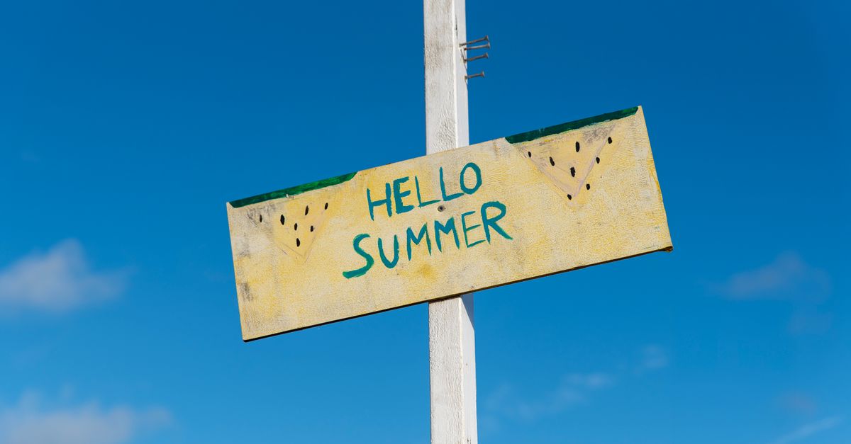 A cheerful 'Hello Summer' sign against a bright blue sky, symbolizing the joyous arrival of summer.